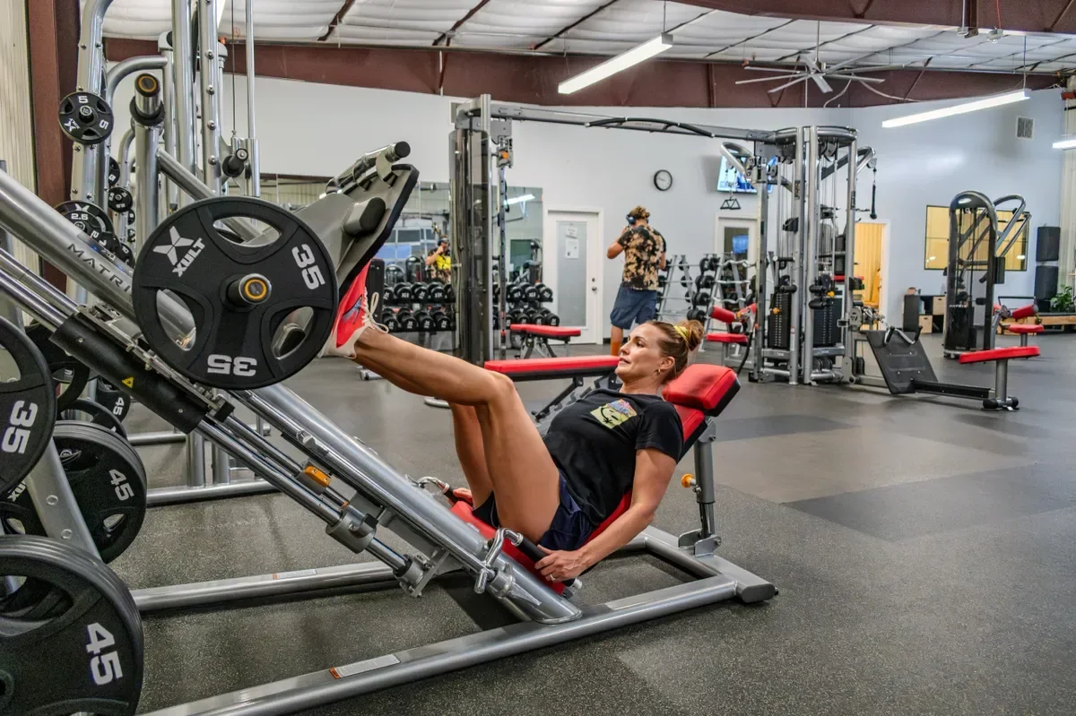 A woman works out on the leg press machine at Arizona Fitness