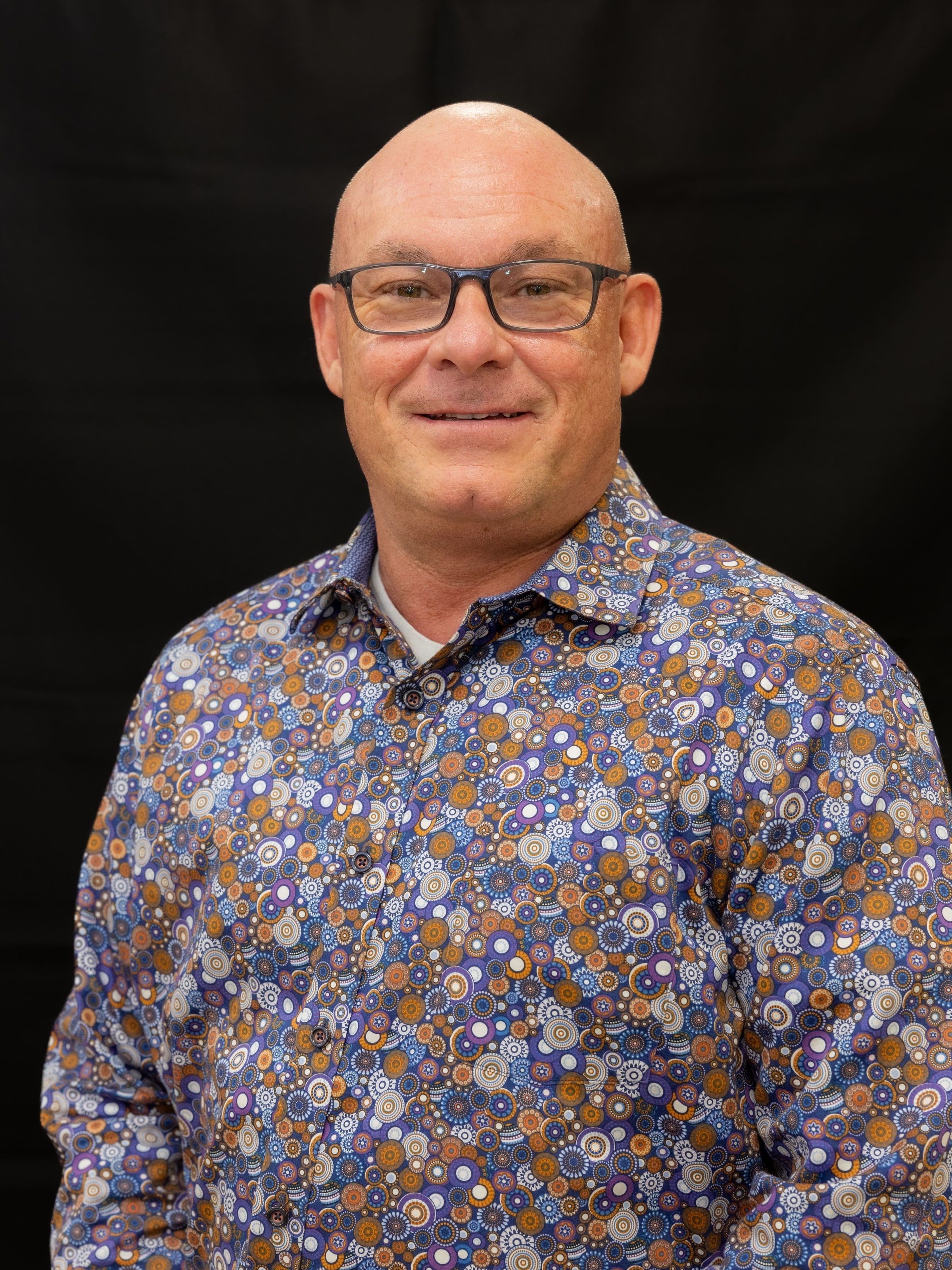 Jim Ball, Lead Pastor, smiling in a patterned shirt